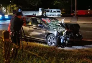 The damaged car lies at the roadside after the late-night hit-and-run in Gurgaon.